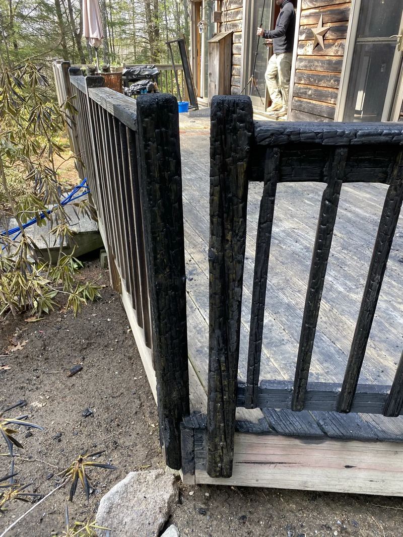 Fire-damaged structural framing exposed after demolition of charred finishes