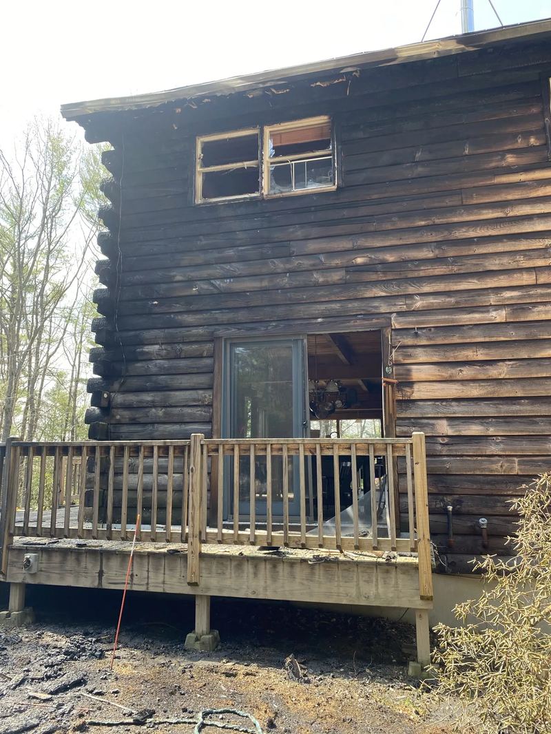 Charred wood framing and insulation removed during fire damage cleanup